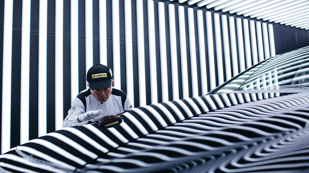 A Lexus employee inspecting a Lexus